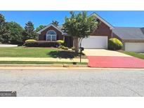 Charming brick home with a well-manicured lawn and inviting curb appeal at 1601 Celestial Ct, Mcdonough, GA 30253