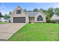 Charming single-Gathering home with well-manicured lawn and attached two-car garage at 147 Calico Loop, Grantville, GA 30220