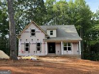 New construction home featuring covered front porch with columns in a wooded setting at 3019 Beverly Ct, Mcdonough, GA 30252