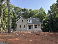 Charming new construction featuring a brick facade and craftsman-style details in a wooded setting at 3019 Beverly Ct, Mcdonough, GA 30252