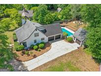 A stunning aerial view shows the home with an in-ground pool, two-car garage, and lush landscaping at 332 Judy Dr, Mcdonough, GA 30253
