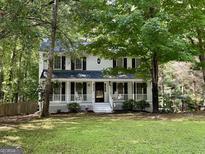 Charming two-story home with inviting front porch and lush landscaping for a warm and welcoming curb appeal at 103 Everhill, Peachtree City, GA 30269
