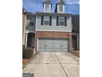 Charming townhome with brick accents and a two-car garage at 3511 Brockenhurst Dr, Buford, GA 30519