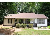 Charming single-story home featuring a covered front porch and well-maintained landscaping at 85 Pine Haven Dr, Carrollton, GA 30116
