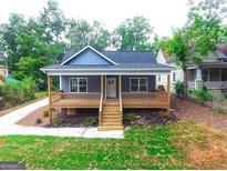 Charming renovated bungalow featuring a welcoming front porch and freshly landscaped front yard at 809 Dill Sw Ave, Atlanta, GA 30310