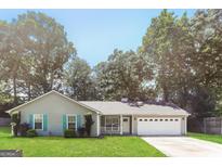 Charming single-story home with a well-manicured lawn and inviting curb appeal at 1421 Oak Knoll Ne Dr, Conyers, GA 30012