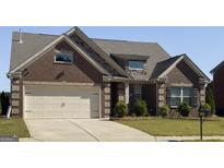 Charming brick home featuring a two-car garage, well-maintained landscaping, and a cozy, inviting curb appeal at 3368 Alhambra Cir, Hampton, GA 30228