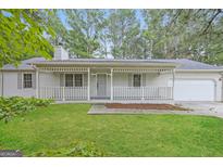 Charming single-story home with a covered porch and well-maintained front yard at 2090 Blackberry Ln, Auburn, GA 30011