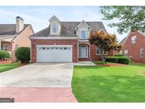 Attractive two-story brick home with a two-car garage and well-maintained landscaping at 1979 Spivey Village Dr, Jonesboro, GA 30236