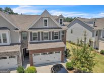 Beautiful two story home with a two car garage, brick and siding, shuttered windows and well maintained landscaping at 2060 Lanier Harbor Pt, Buford, GA 30518