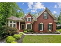 Charming brick home with manicured landscaping and classic architectural details at 770 Spalding Heights Dr, Atlanta, GA 30350