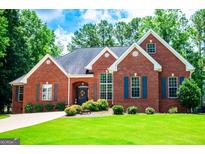Charming brick home with a manicured lawn and mature trees offering classic curb appeal at 109 National Way, Carrollton, GA 30116