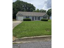 Charming single-story home features a well-manicured lawn, and an attached single car garage at 2985 Garnet Way, South Fulton, GA 30349