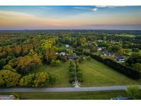 Expansive aerial view of a property with a long driveway, lush greenery, and a serene, wooded landscape at 3700 Tom Brewer Road, Loganville, GA 30052