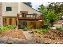 Two-story townhome featuring a charming front yard, wooden deck, and walkway at 44 Twiggs Cor, Peachtree City, GA 30269