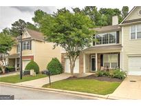 Charming townhome featuring a well-maintained front yard and a one-car garage at 1643 Jackson Way, Atlanta, GA 30318