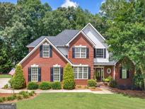 Charming two-story brick home with black shutters and a well-manicured lawn at 4147 Alayna Lee Cir, Mcdonough, GA 30252