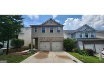 Charming two-story home featuring a two-car garage, stone accents, and well-maintained landscaping at 305 Hidden Creek Ln, Canton, GA 30114
