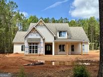 Inviting exterior view of a charming new construction home with a spacious front yard and a welcoming porch at 4 Bob Smith Rd, Sharpsburg, GA 30277
