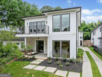 Modern two-story home showcasing a balcony, front porch, landscaped yard, and inviting curb appeal at 32 Walthall Ne St # A, Atlanta, GA 30307