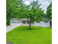 Charming single-story home featuring a well-maintained lawn and a classic white exterior at 120 Lakeside Dr, Ellenwood, GA 30294