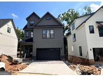 New construction two-story home with a dark garage door and neutral-colored siding at 3024 Trae Ct, Smyrna, GA 30080