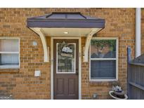 Inviting brick home entryway featuring a welcoming door with decorative wreath and charming details at 105 N River Dr # G, Sandy Springs, GA 30350