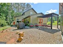 Inviting backyard patio with an outdoor grill and ample seating, great for entertaining guests at 460 Morgan Mill Rd, Brooks, GA 30205