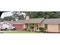Charming single-story home featuring stone accents and a covered front porch at 10359 Briarbay Loop, Jonesboro, GA 30238