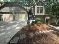 Charming home with two-car garage, landscaped front yard, and inviting entryway at 2532 N Carroll Ct, Villa Rica, GA 30180