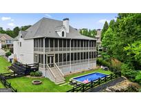 Stunning home with an outdoor pool and screened in back porch with a well maintained lawn and privacy at 6017 Chestatee Creek Nw Ct, Acworth, GA 30101