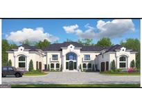 Elegant home with a circular driveway, manicured landscaping, and a striking architectural design at 4309 Giverny Blvd, Fairburn, GA 30213