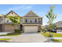 Charming two-story townhome featuring a two-car garage and traditional architectural details at 2829 Wild Laurel Ct, Norcross, GA 30071