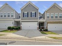 Charming townhome featuring a one-car garage, well-maintained landscaping, and inviting curb appeal at 36 Crescent Chase, Dallas, GA 30157
