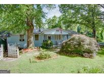 Inviting home with a well-manicured front yard and mature trees, offering curb appeal at 4236 Florida Nw Ave, Atlanta, GA 30360