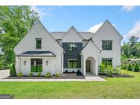 Beautiful two-story home with a well-manicured lawn, brick exterior, and elegant front facade at 103 Maddox Rd, Buford, GA 30518