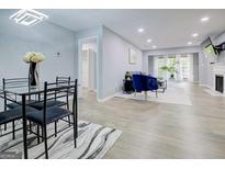 Bright living space with updated floors, lighting, and open floorplan concept into the dining area at 24317 Plantation Ne Dr, Atlanta, GA 30324