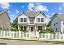 Charming two-story home features a welcoming porch and a lovely white picket fence at 3725 Downing Dr, Cumming, GA 30040
