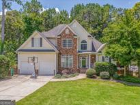 Charming two-story home with a stone facade and a well-manicured lawn at 119 Creekside Vw, Hiram, GA 30141