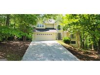 Charming two-story home featuring a well-manicured lawn, two car garage, and a welcoming front entrance at 3626 Lone Indian Trl, Marietta, GA 30066