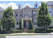 Charming three-story brick townhouse with well-manicured landscaping and a classic, symmetrical facade at 4107 Township Pkwy # 69, Sandy Springs, GA 30342