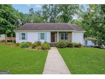 Charming single-story home with a lush lawn, stone accents, and inviting walkway at 792 Mimosa Se Dr, Marietta, GA 30060