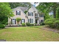 Charming two-story home with a manicured front yard, lush landscaping, and black shutters, giving great curb appeal at 1285 Willow Park Way, Cumming, GA 30041
