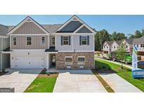 Charming two-story townhome with a single-car garage and well-maintained front lawn at 179 Stanchion Dr, Union City, GA 30291