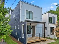 Striking two-story home with modern design and covered front porch, enhanced by sleek architectural details at 569 Middle Sw St, Atlanta, GA 30310