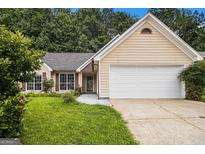 Charming single-Gathering home with a two-car garage and manicured front lawn at 1055 Avalon Dr, Lawrenceville, GA 30044