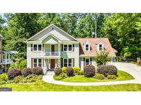 Charming two-story home with manicured landscaping and a welcoming front porch, perfect for Southern charm at 115 Edgewater Way, Peachtree City, GA 30269