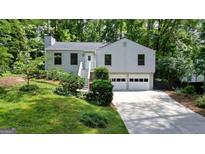 Charming two-story home with a two-car garage and inviting front yard at 7025 Stone Wood Nw Dr, Kennesaw, GA 30152