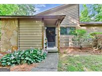 Inviting front entrance with a stone accent wall and well-maintained landscaping adding curb appeal at 830 Bonnie Glen Se Dr, Marietta, GA 30067