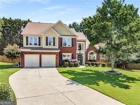 Charming two-story brick home with manicured lawn and two-car garage, inviting curb appeal at 2740 Greymont Ct, Cumming, GA 30041